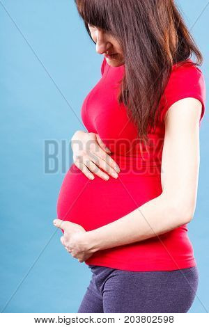 Sad Pregnant Woman With Stomach Pain Touching Her Belly, Concept Of Aches In Pregnancy And Risk Of M