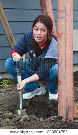 Woman Digs Post Hole For Habitat For Humanity