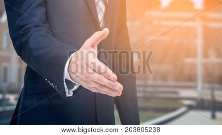 Business offer partnership. Businessman holds out his hand.