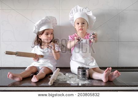 happy family funny kids are preparing the dough, bake cookies in the kitchen.