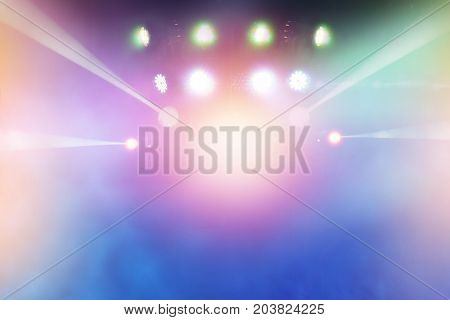 multi-colored light beams from the stage of the entertainment show. nightlife with music and entertainment abstract background with defocused bokeh light.