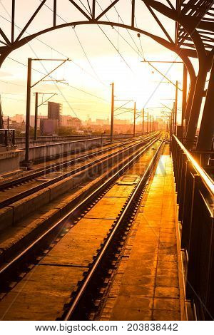 Railway station at platform in the eveningSunset of railroad tracks
