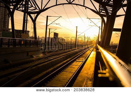 Railway station at platform in the eveningSunset of railroad tracks