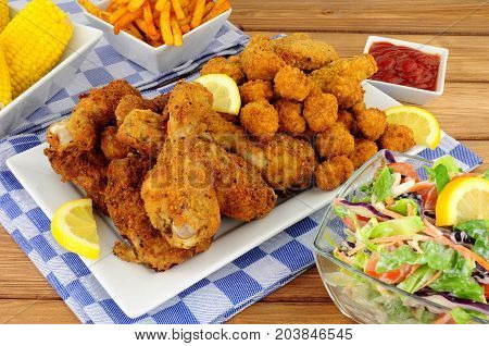 Collection of Southern fried chicken products with sweetcorn and salad