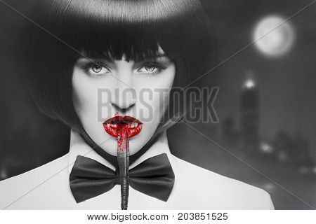 Sexy hungry dominant vampire bite bloody whip at night selective coloring