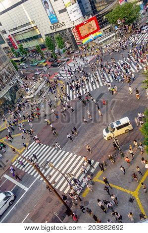 TOKYO, JAPAN JUNE 28 - 2017: Top view of crowd of people crossing in Shibuya street, one of the busiest crosswalks in the world, in the Ginza District in Tokyo, Japan.