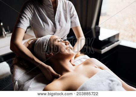 Beautiful young woman enjoying massage and rejuvenating