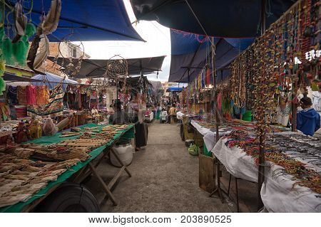 April 29 2017 Otavalo Ecuador: indigenous quechua people selling artisan gifts on stands set up on the street in the Saturday market