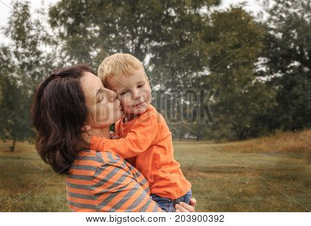 Mom and little son in the park. Concept happy childhood. Copyspace