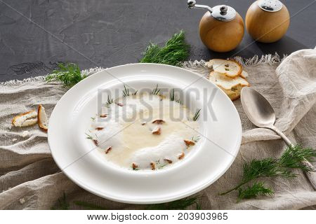 Delicious cream soup with honey fungus. Gourmet meal with mushrooms and crusty bread, restaurant serving