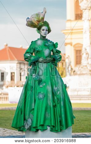 TIMISOARA, ROMANIA - September 08, 2017: Portrait of a woman in green dress at the CheckArt Carnival. Living statue. Union Square.