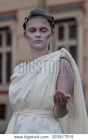 TIMISOARA, ROMANIA - September 08, 2017: Portrait of a woman in white dress at the CheckArt Carnaval. Living statue. Union Square.