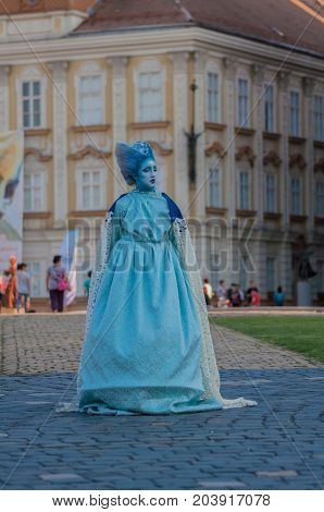 TIMISOARA, ROMANIA - September 08, 2017: Portrait of a woman in blue dress at the CheckArt Carnaval. Living statue. Union Square.