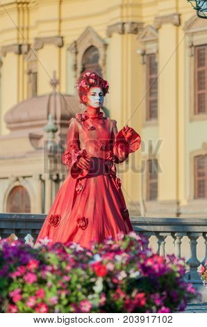 TIMISOARA, ROMANIA - September 08, 2017: Portrait of a woman in red dress at the CheckArt Carnaval. Living statue. Union Square.
