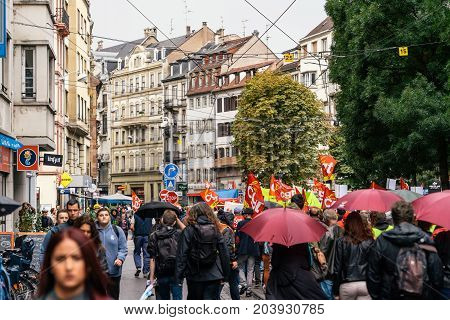 STRASBOURG FRANCE - SEPT 12 2017: Demonstrators walks on street under rain during a French Nationwide day of protest against the labor reform proposed by Emmanuel Macron Government