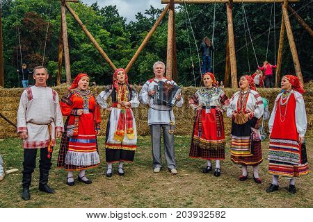 Voronezh, Russia - September 08, 2017: Traditional Russian folklore ensemble at the fair, accordionist and singers in traditional Russian ethnic suit for Voronezh Region