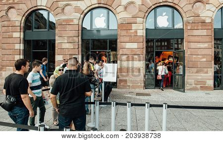 STRASBOURG FRANCE - SEP 20 2014: Customers waiting in line to pick-up their new reserved iPhone 7 from the Apple Store computer store selling iPad Apple Watch and iMac MacBook pro computers