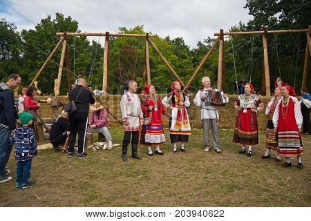 Voronezh, Russia - September 08, 2017: Traditional Russian folklore ensemble at the fair, accordionist and singers in traditional Russian ethnic suit for Voronezh Region