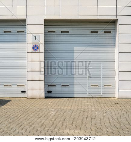Two large automatic up and over garage door with inclusion of smaller personal door.