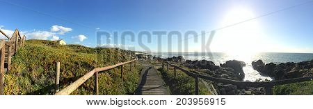 Amazing panoramic landscape of the mountain and the beach with the boardwalk in the middle