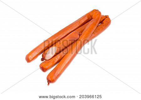 Several whole and one half of the long thin smoked hunting frankfurters in the natural casing on a light background