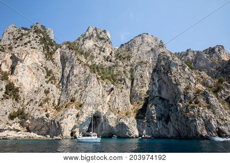 CAPRI ITALY - JUNE 13 2017: Boats with tourists near Grotta Bianca and Grotta Meravigliosa Capri Italy