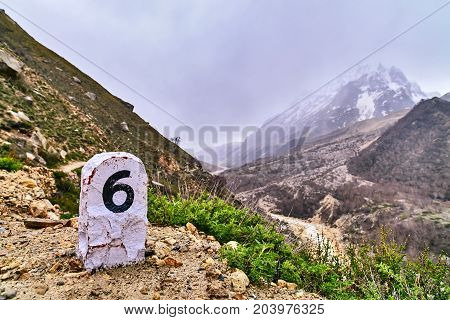Kilometer stone in Himalaya mountains. Gaumukh glacier Gangotri Uttarakhand India.