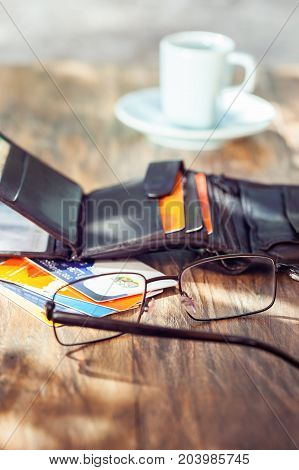 Leather men's open wallet with credit cards  eyeglass and coffee cup
