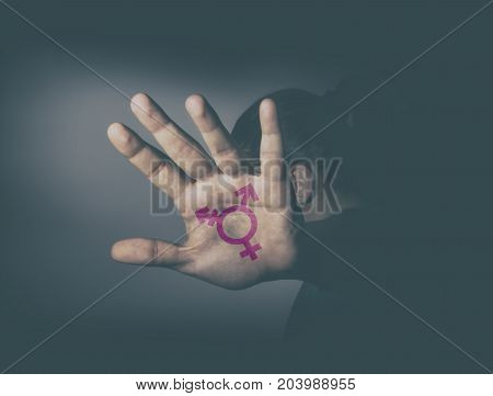 Transgender symbol painted in the palm of unrecognizable person