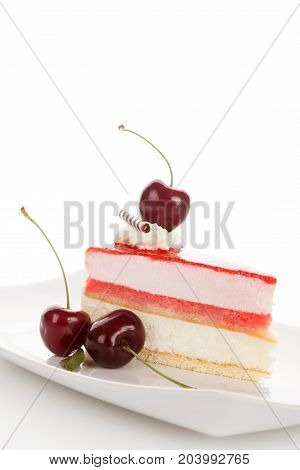 Delicious sweet cherry cake with cherries on white plate. Isolated on white background
