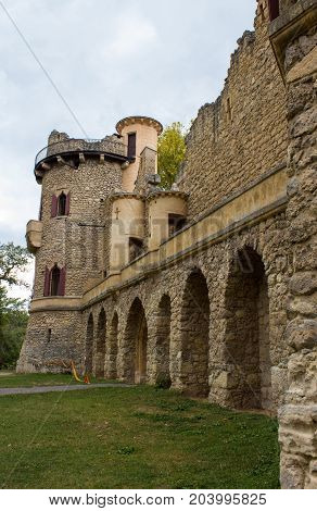 Jans castle - arches in castle walls. There is a green lawn around the castle.
