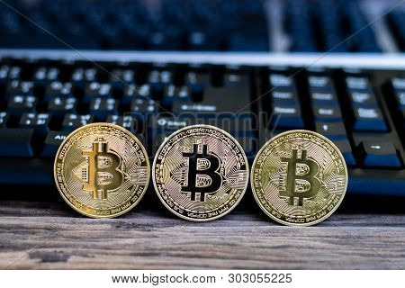 Bitcoin With Black Keyboard On Old Wood