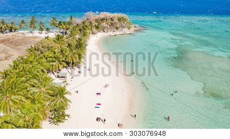 Aerial Seascape Tourists Enjoy The Tropical Beach. Tropical Island With Sand Beach, Palm Trees. Malc