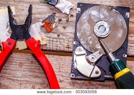 A Man Breaks A Computer Using Locksmith Tools.