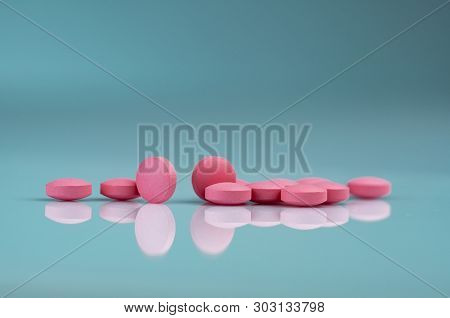Round Pink Tablets Pill On Gradient Background. Vitamins And Minerals Plus Folic Acid Vitamin E And 