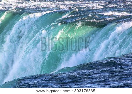 Gorgeous View Of Niagara Falls Landscape.waves Rumbling Against The Rocky Shore. Beautiful Nature Ba