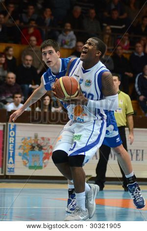 KAPOSVAR, HUNGARY â FEBRUARY 18: Kwadzo Ahelgebe (in white) in action at a Hungarian Championship basketball game with Kaposvar (white) vs. Fehervar (blue) on February 18, 2012 in Kaposvar, Hungary.