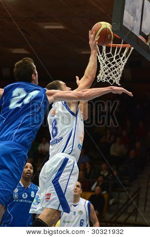 KAPOSVAR, HUNGARY â FEBRUARY 18: Unidentified players in action at a Hungarian Championship basketball game with Kaposvar (white) vs. Fehervar (blue) on February 18, 2012 in Kaposvar, Hungary.