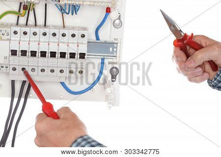 Electrician Is Repairing A Device Box With Tools