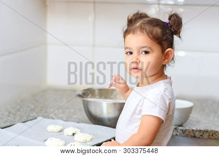 Kid Helping At House In Kittchen. Little Child Girl Making Cookies On Marble Table. Happy Family Fun