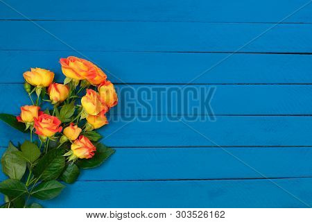 Background Of Bouquet Of Beautiful Fresh Vivid Orange Roses Tinged With Red For Celebrating An Anniv