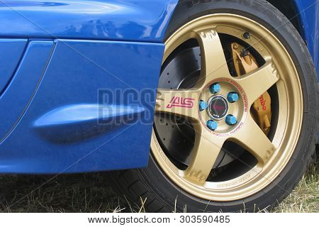 Moscow, Russia - May 25, 2019: Blue Subaru Wrx Sti On The Grass, Close Up Of Light Alloy Wheel In Go