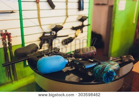 Paintball Guns On A Wooden Table. Play Paintball.