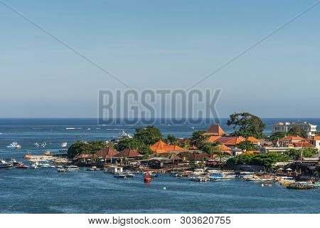 Benoa Harbour, Bali, Indonesia - February 26, 2019: The Red Roofs Of The Buildings On Tip Of Tanyung