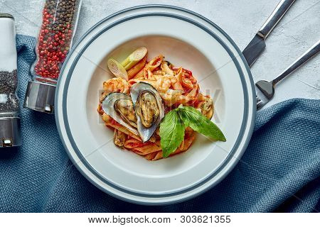 Pasta With Seafood And Tomato Sauce. Penne With Shrimp, Octopus, Mussels, Vongli In Tomato Sauce Wit