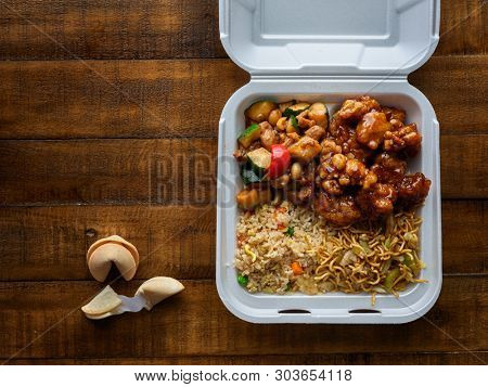 chinese take out with fried rice and general tsos chicken on table top
