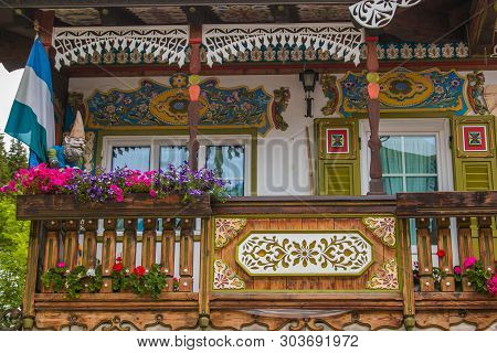 Canazei, Italy - July 15, 2018: Detail Of Traditional Fully Decorated House In The Center Of Canazei