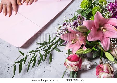Florist Girl Works And Creates A Beautiful Modern Large Bouquet With Lilies. Femaly Hands. Top View,