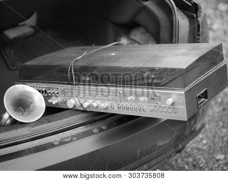 Transporting Retro Vinyl Player In An Open Car Boor, In Black And White