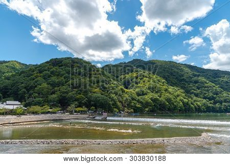 Togetsu-kyo Bridge Over Katsuragawa River With Colourful Forest Mountain Background In Arashiyama Di